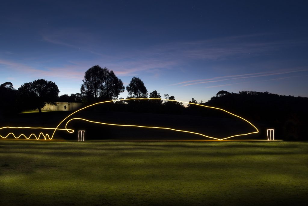 A simulated cricket match on the Hill End Oval using lights to represent the trajectory of a cricket ball.