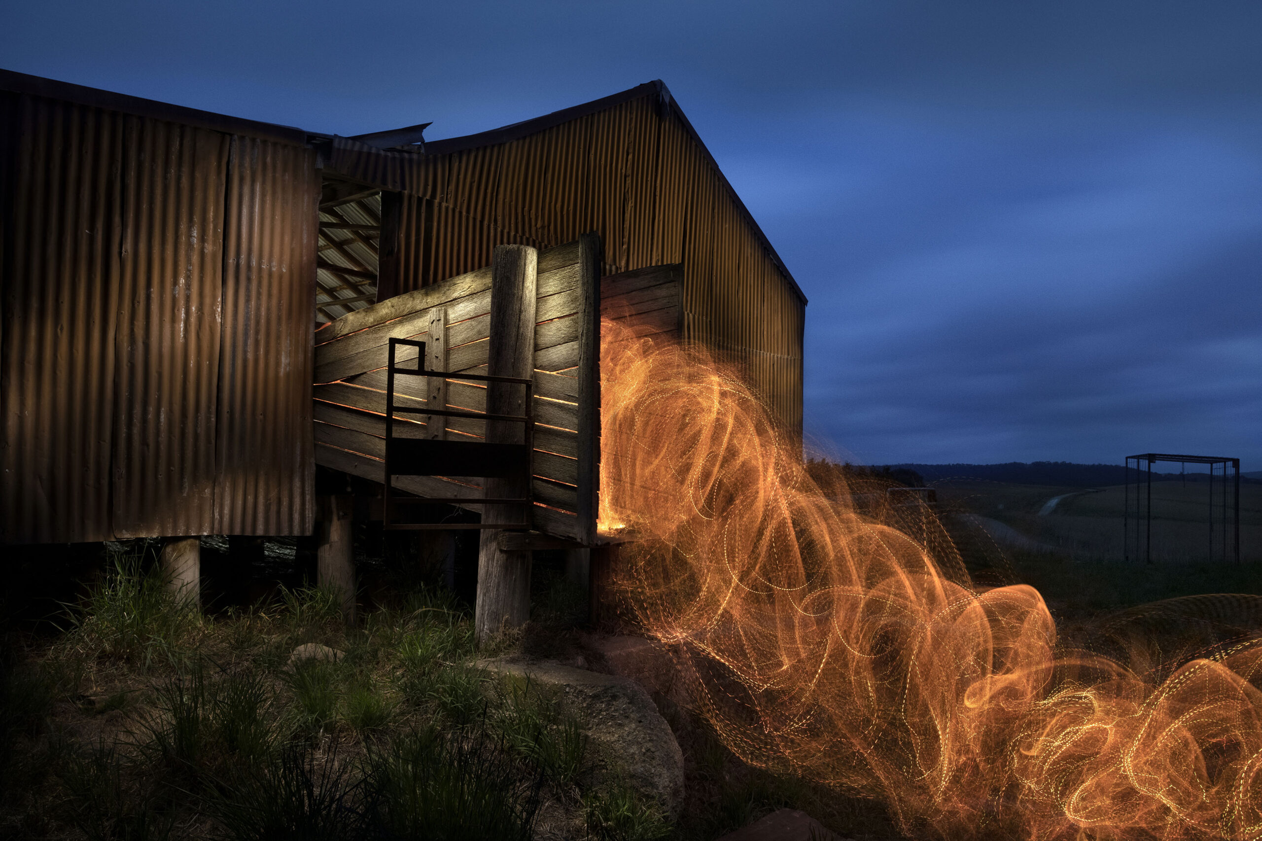 A rural shed illuminated after dark